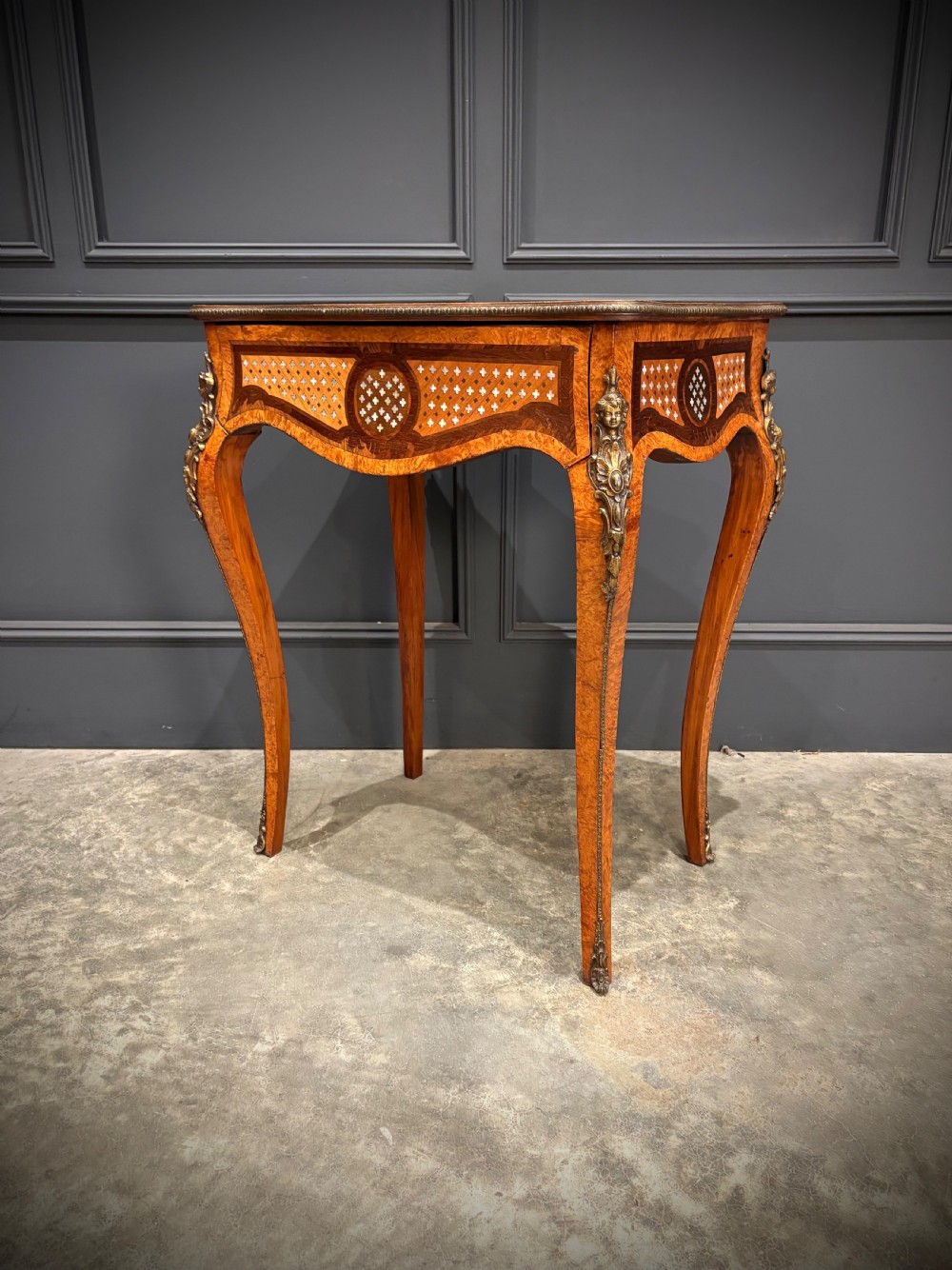 French style side table featuring geometric lattice marquetry inlay, cabriole legs, and gilded bronze ormolu mounts. View X