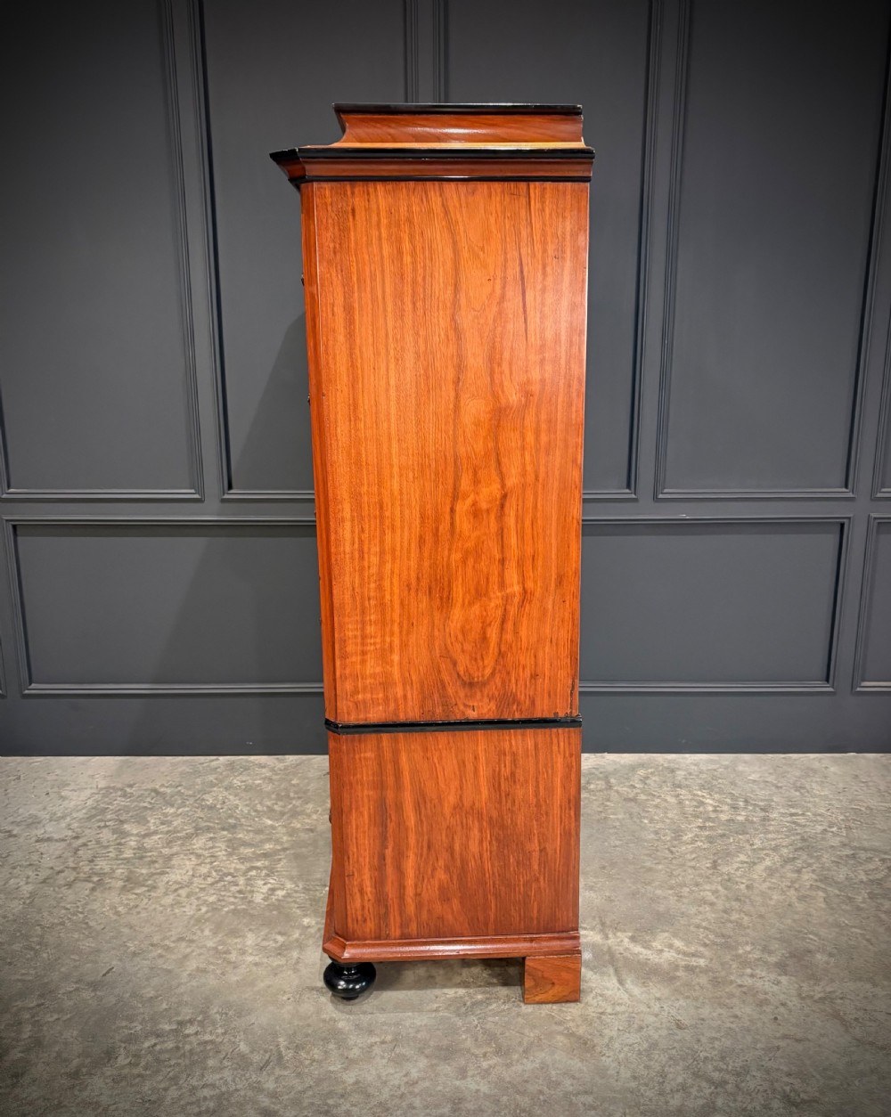 A tall 19th-century burr walnut chest of drawers featuring seven graduated drawers with brass escutcheons and ebonised mouldings set on turned front feet. View VIII
