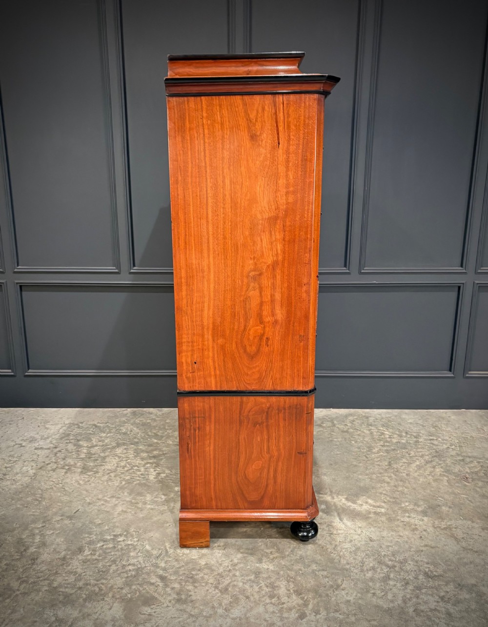 A tall 19th-century burr walnut chest of drawers featuring seven graduated drawers with brass escutcheons and ebonised mouldings set on turned front feet. View X