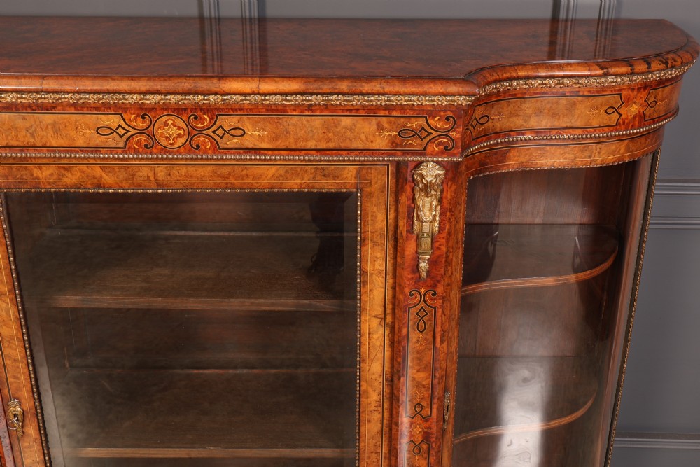 A Victorian burr walnut credenza with intricate marquetry inlay, gilt bronze mounts, and glazed display sections. View V
