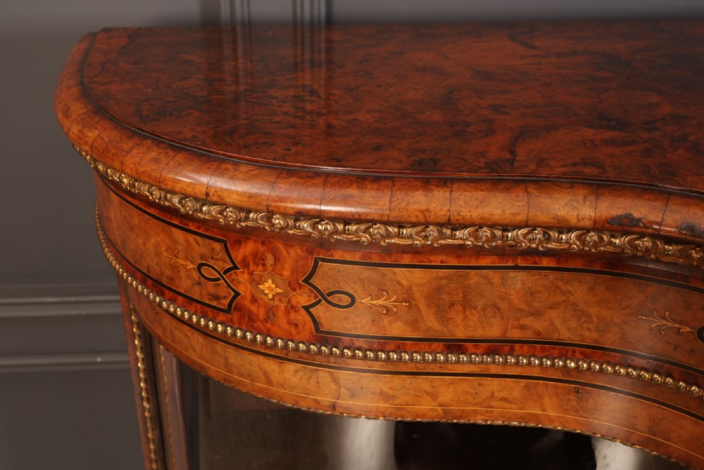 A Victorian burr walnut credenza with intricate marquetry inlay, gilt bronze mounts, and glazed display sections. View VIII