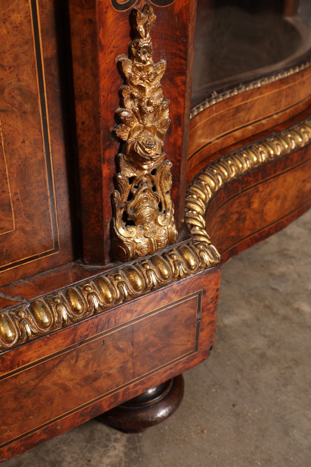 A Victorian burr walnut credenza with intricate marquetry inlay, gilt bronze mounts, and glazed display sections. View XI