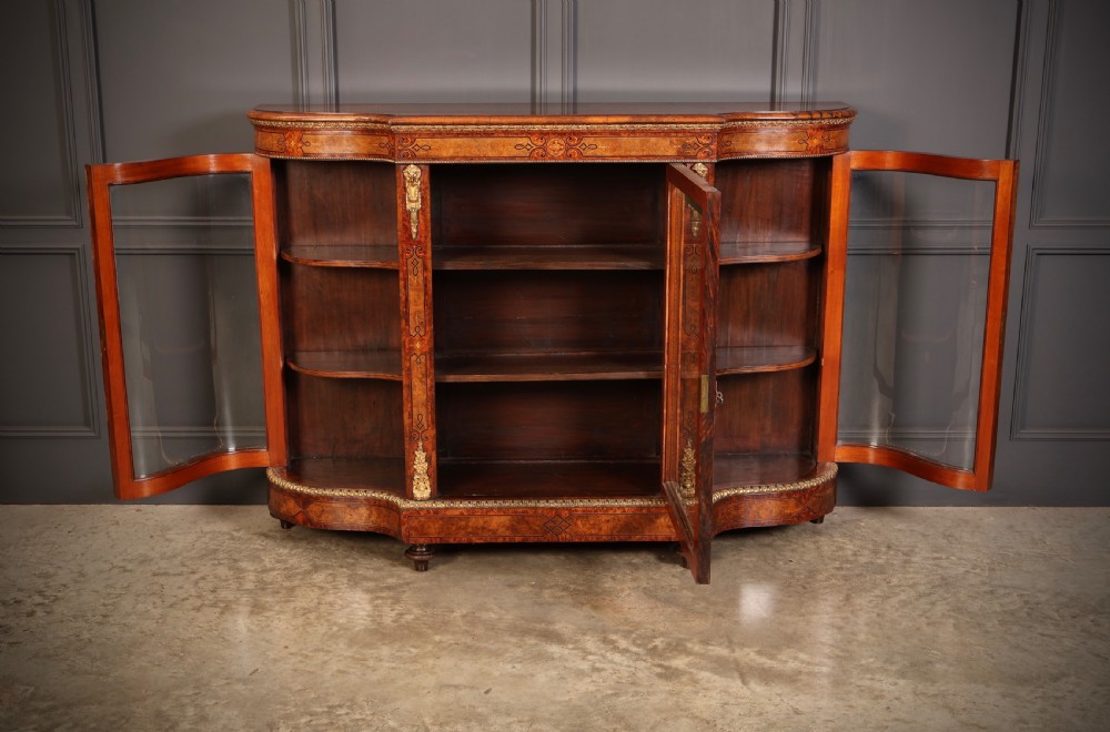 A Victorian burr walnut credenza with intricate marquetry inlay, gilt bronze mounts, and glazed display sections. View XII