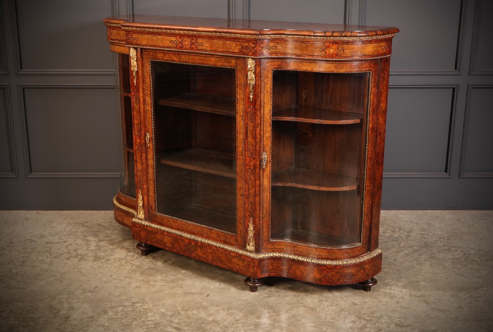 A Victorian burr walnut credenza with intricate marquetry inlay, gilt bronze mounts, and glazed display sections. View XIV