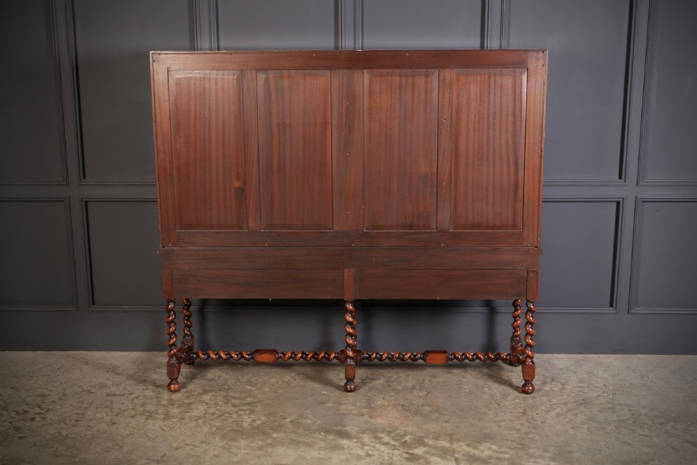 A double bow-front burr walnut cocktail cabinet featuring carved scrollwork on the lower apron, supported by six barley twist legs joined by stretchers. View XIII