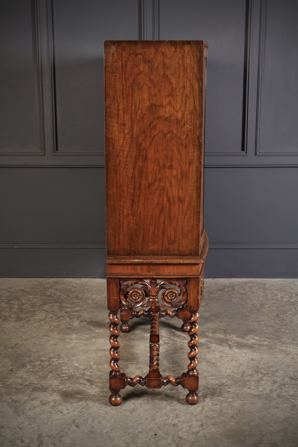 A double bow-front burr walnut cocktail cabinet featuring carved scrollwork on the lower apron, supported by six barley twist legs joined by stretchers. View XIV
