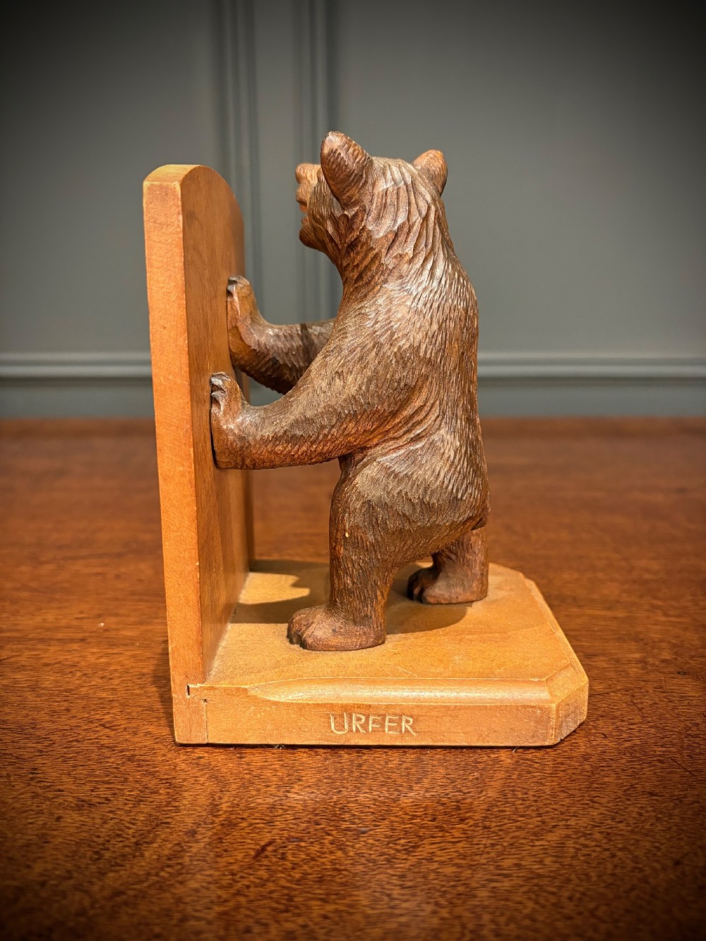 A pair of hand-carved wooden bookends depicting standing bears with open mouths pushing against vertical wooden supports. View V