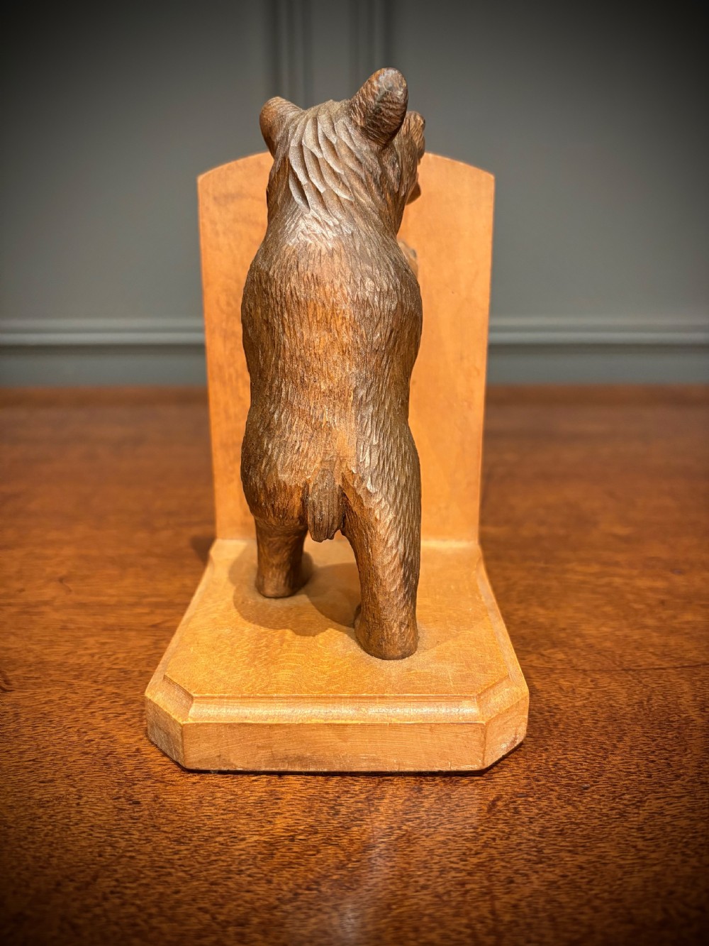 A pair of hand-carved wooden bookends depicting standing bears with open mouths pushing against vertical wooden supports. View VI