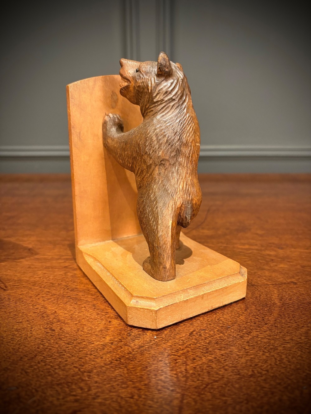 A pair of hand-carved wooden bookends depicting standing bears with open mouths pushing against vertical wooden supports. View VII