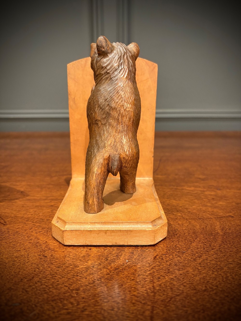 A pair of hand-carved wooden bookends depicting standing bears with open mouths pushing against vertical wooden supports. View VIII