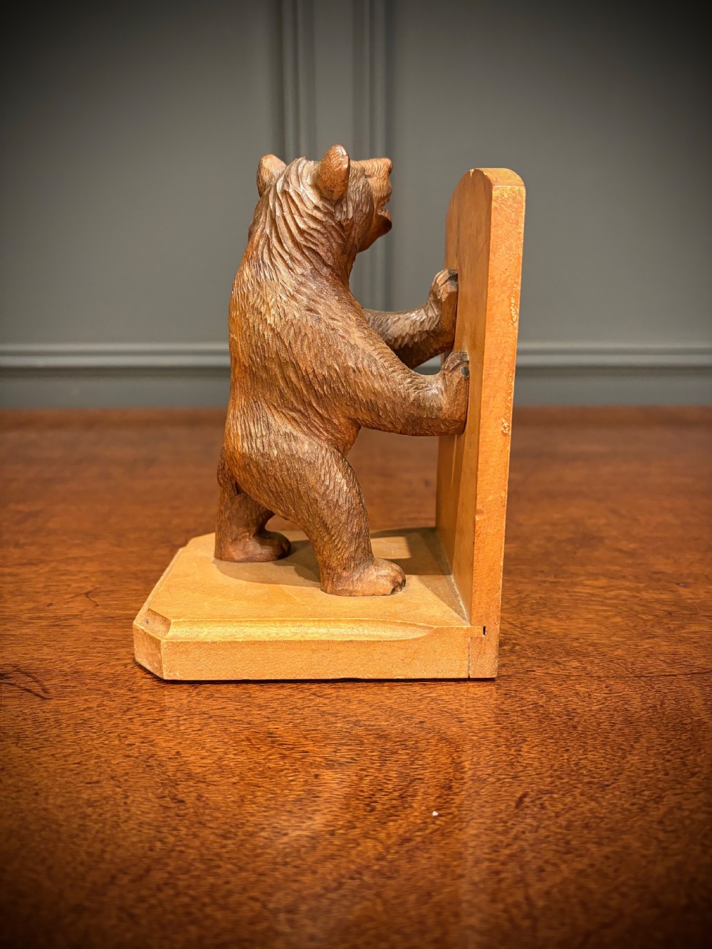 A pair of hand-carved wooden bookends depicting standing bears with open mouths pushing against vertical wooden supports. View IX