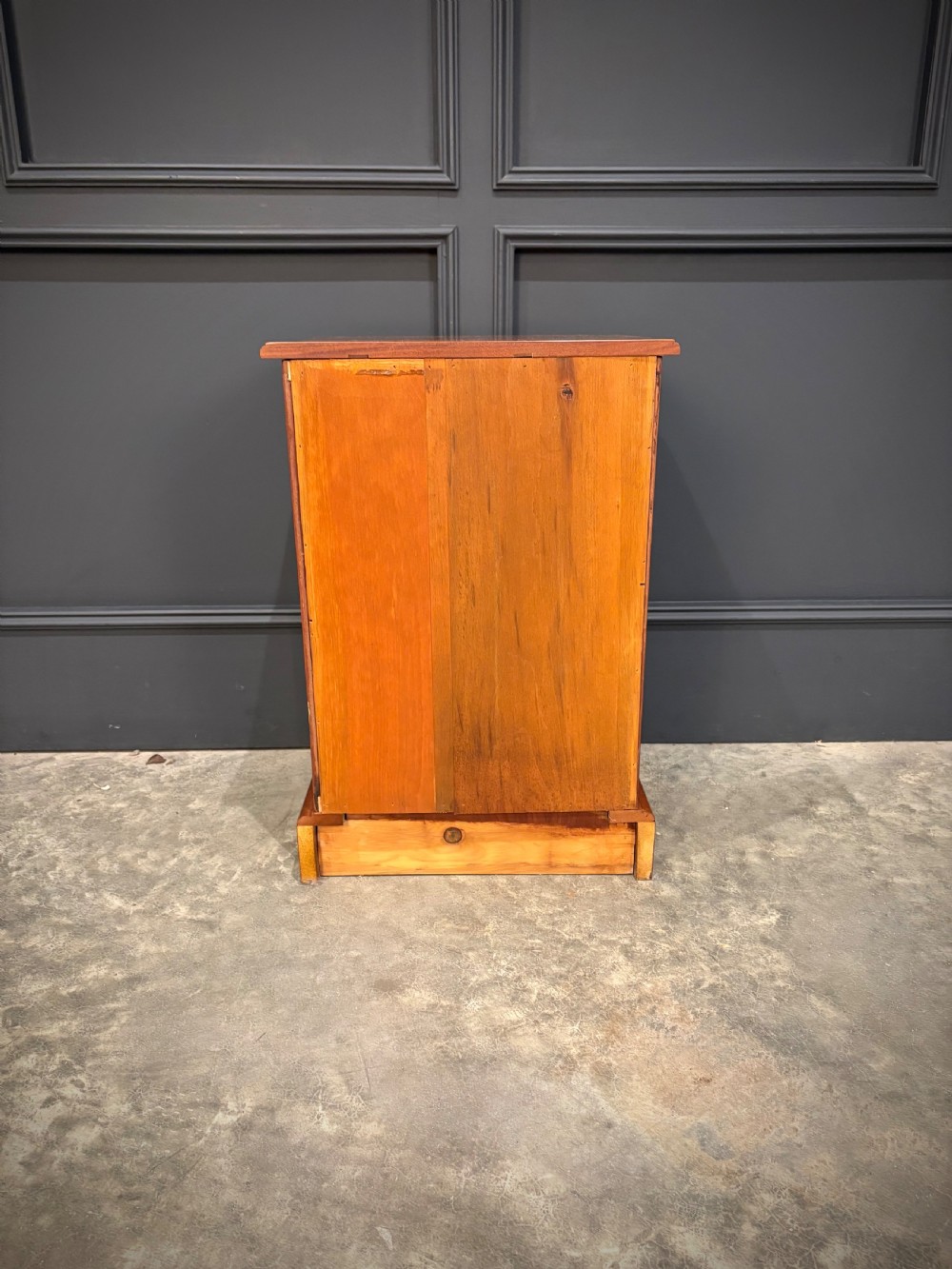 A pair of Victorian mahogany bedside chests, each featuring three drawers with brass drop ring handles on a solid plinth base. View XII
