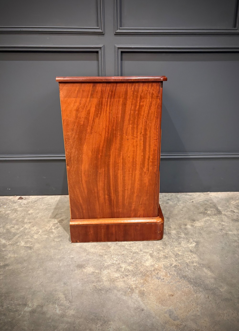A pair of Victorian mahogany bedside chests, each featuring three drawers with brass drop ring handles on a solid plinth base. View XIII