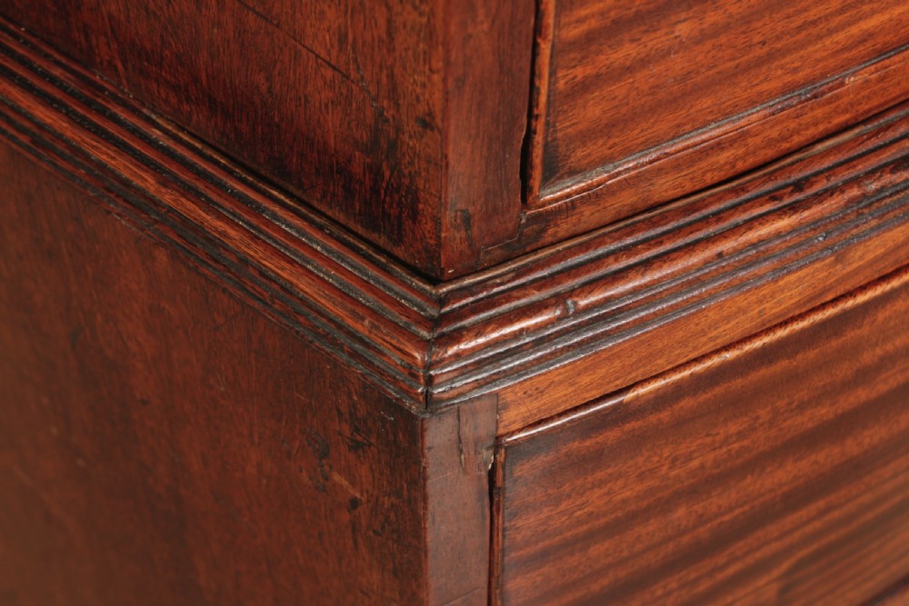 A tall Regency mahogany bowfront chest on chest featuring a curved front face with stacked drawers and splayed bracket feet. View XIII