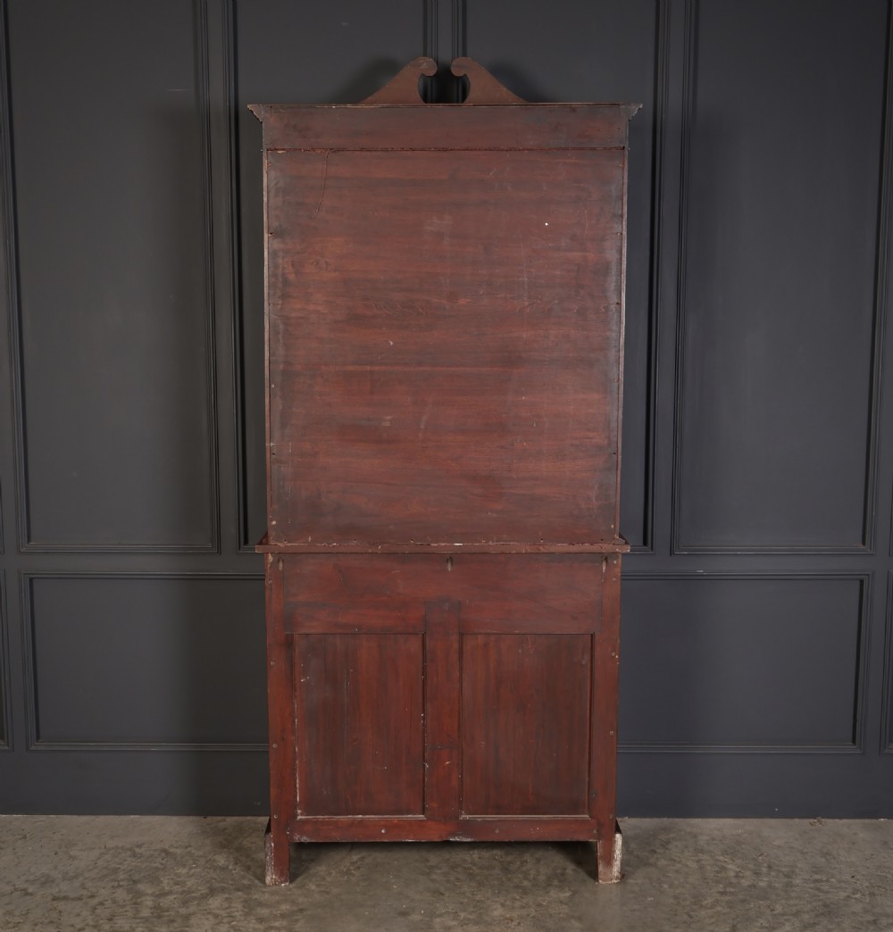 A tall mahogany glazed cabinet bookcase featuring marquetry inlay, astragal glazed doors, a swan-neck pediment, and a two-door lower cupboard. View XI