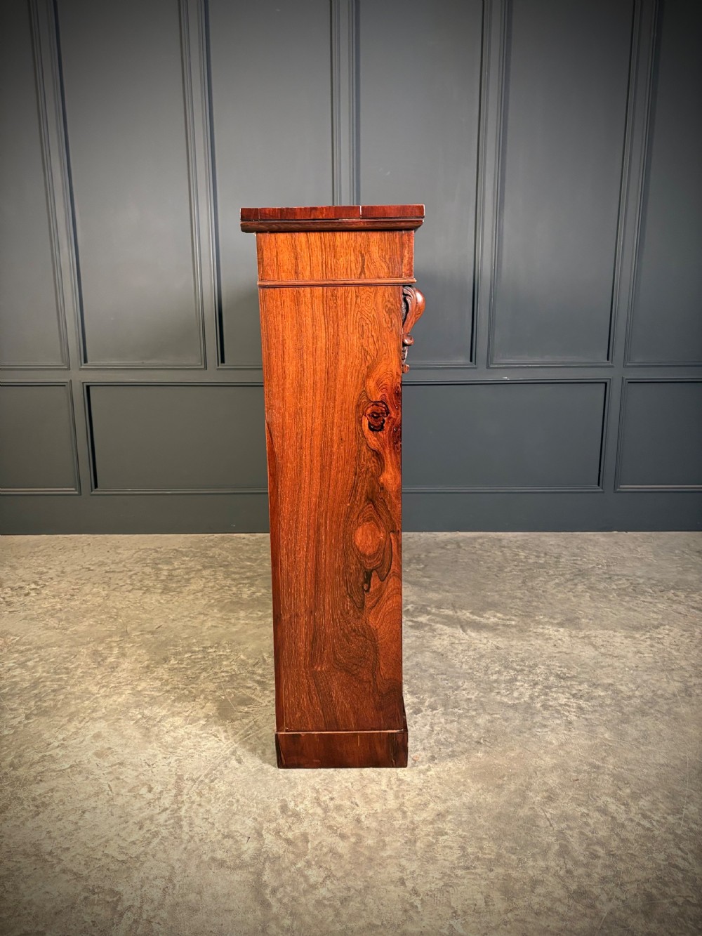 A low Victorian open bookcase made from dark rosewood with two bays of adjustable shelves and carved corbels. View IX