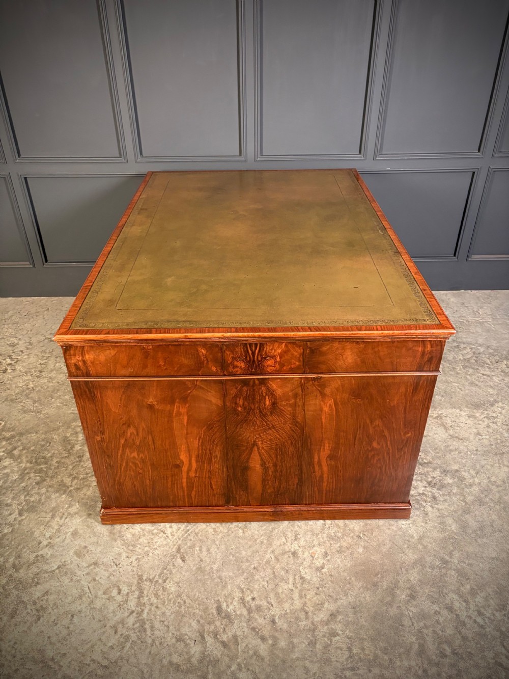 A large Victorian walnut partners desk featuring a green leather inset top, dual pedestals with multiple drawers, and brass handles. View XI