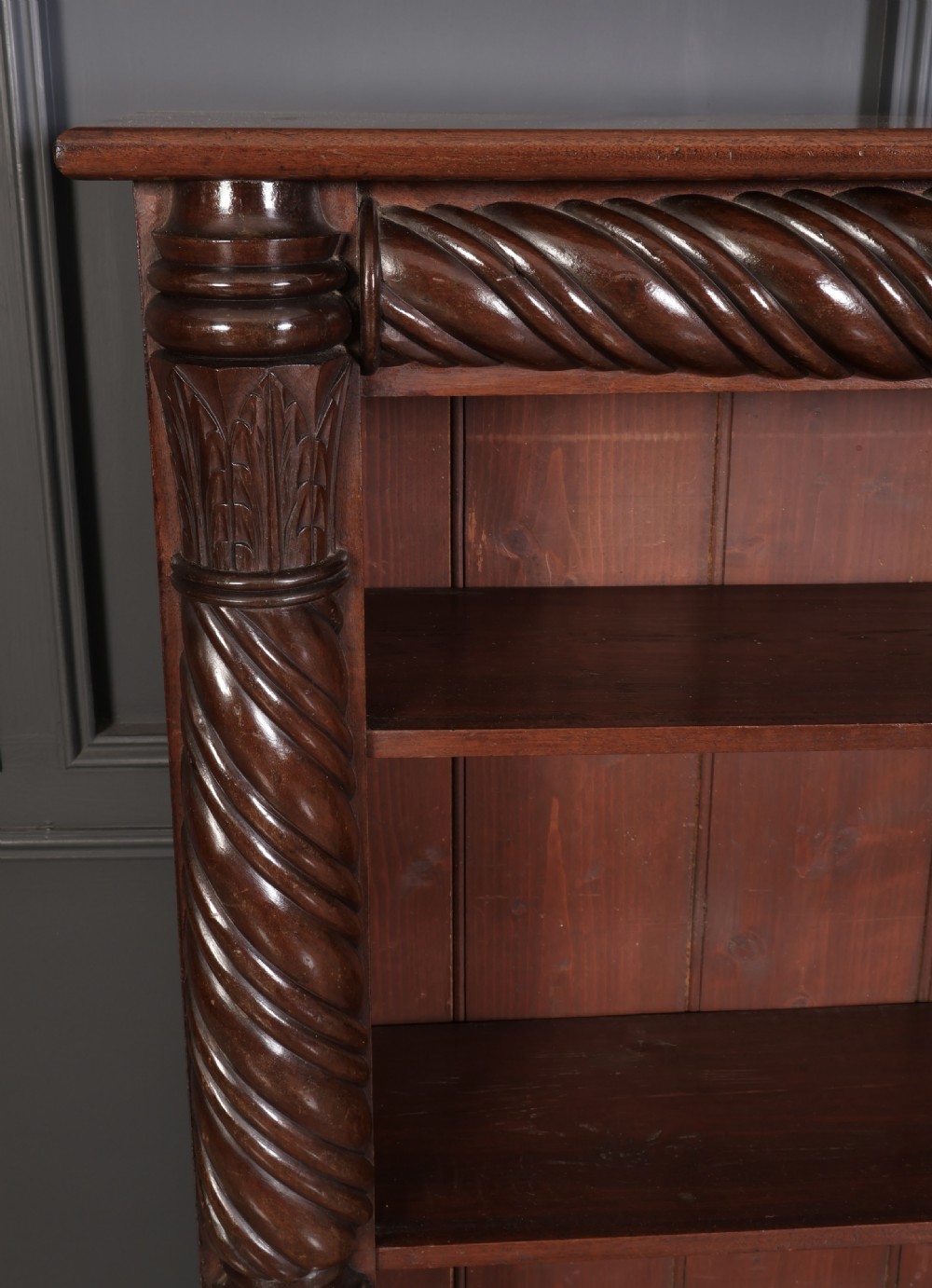 A William IV dark mahogany open bookcase featuring four shelves flanked by spiral twist carved columns and a detailed frieze. View II