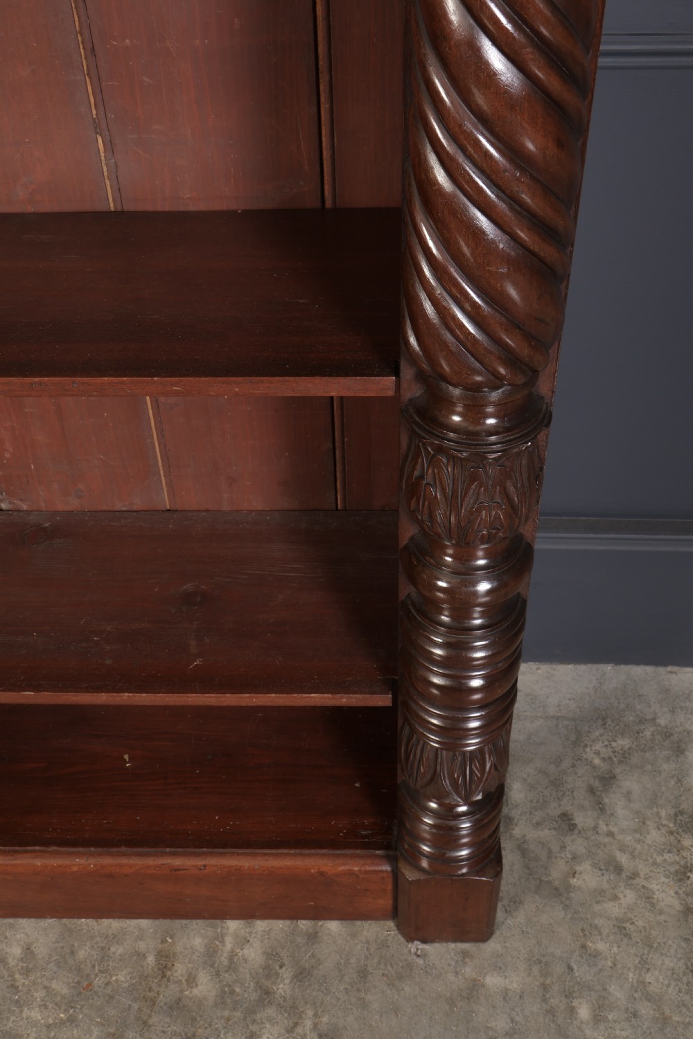 A William IV dark mahogany open bookcase featuring four shelves flanked by spiral twist carved columns and a detailed frieze. View III