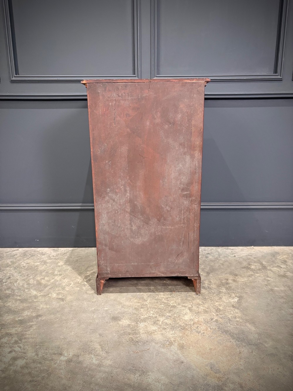 A pair of antique rich mahogany bedside cabinets featuring single arched panel doors and solid plinth bases. View X