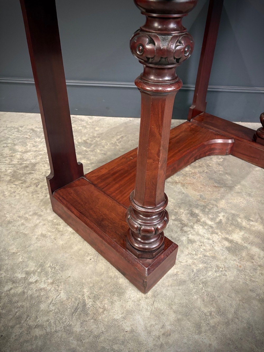 An antique dark mahogany console table featuring carved turned columns and a solid plinth base. View III