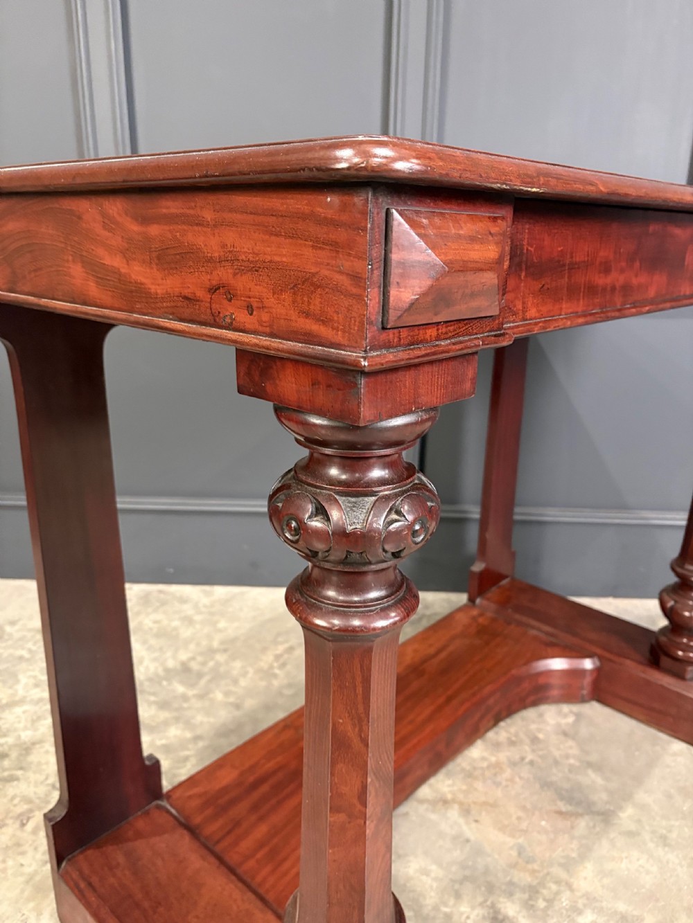 An antique dark mahogany console table featuring carved turned columns and a solid plinth base. View IV