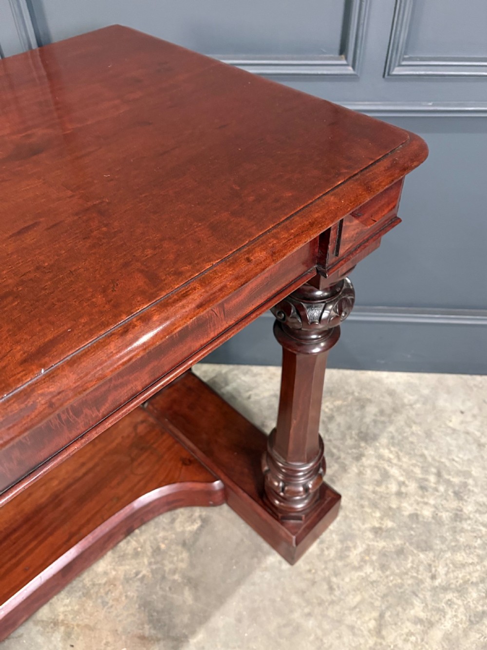 An antique dark mahogany console table featuring carved turned columns and a solid plinth base. View V