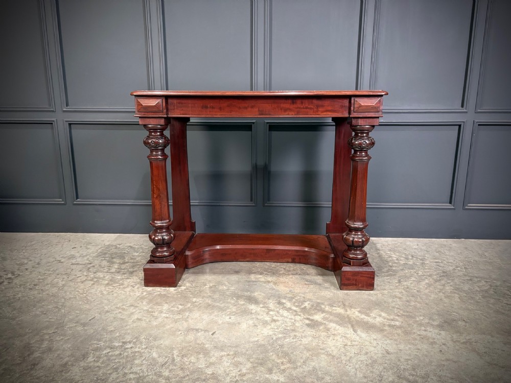 An antique dark mahogany console table featuring carved turned columns and a solid plinth base. View VII