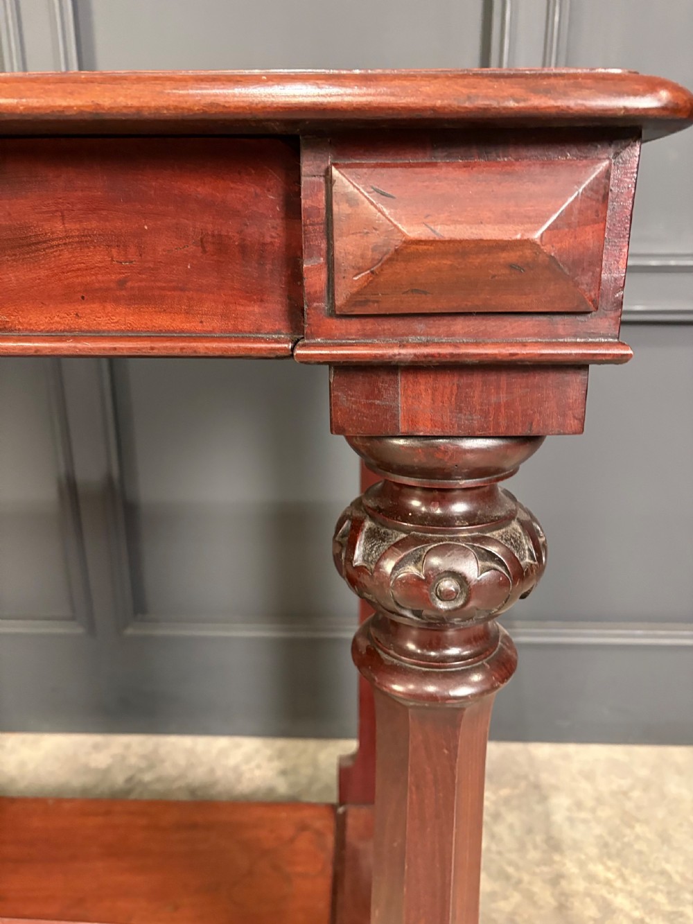 An antique dark mahogany console table featuring carved turned columns and a solid plinth base. View VIII