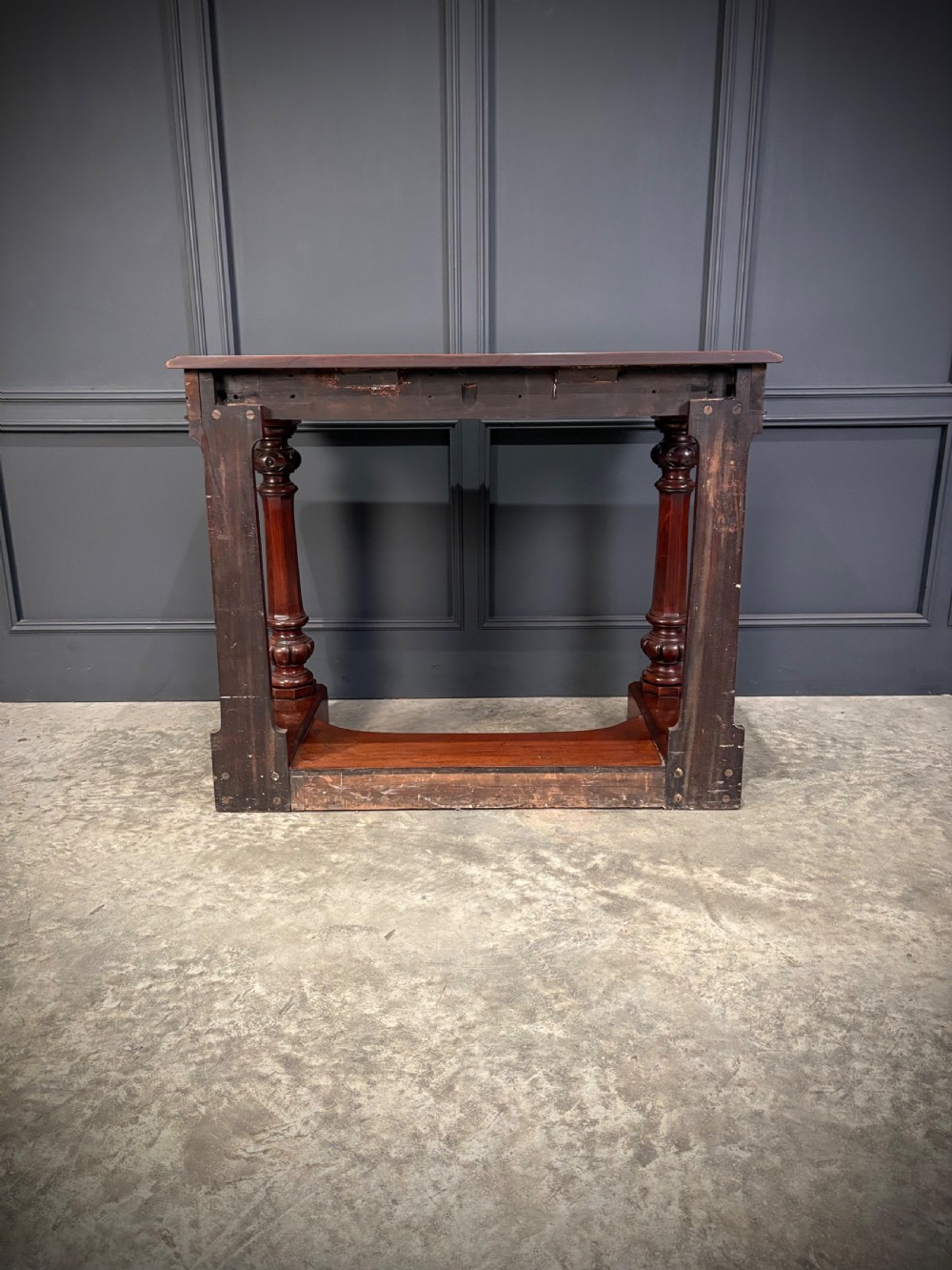 An antique dark mahogany console table featuring carved turned columns and a solid plinth base. View XIII