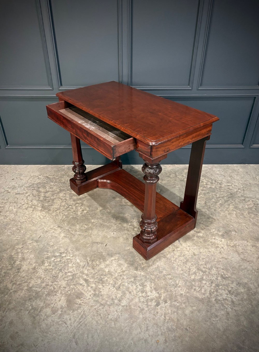An antique dark mahogany console table featuring carved turned columns and a solid plinth base. View XV