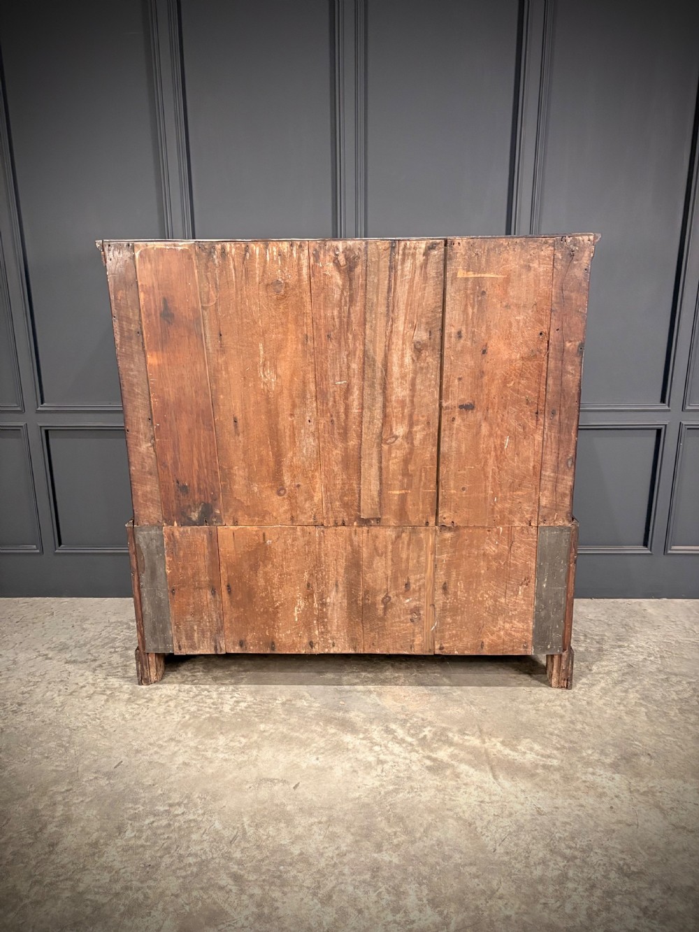 An 18th-century dwarf oak housekeepers cupboard featuring twin doors with pointed arch fielded panels over a base of five drawers. View VII