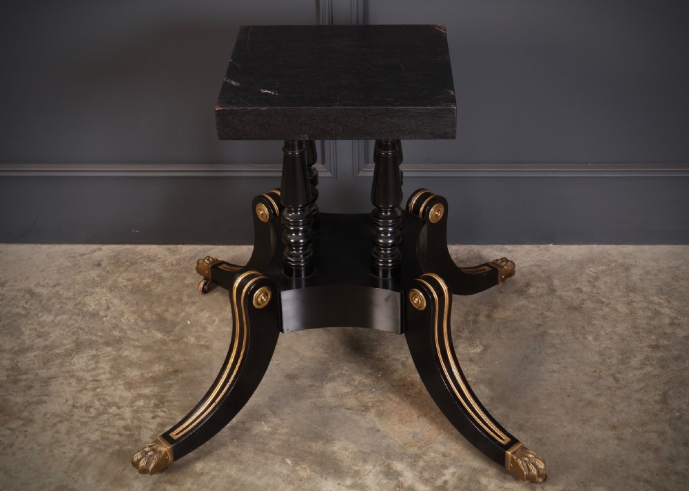 A circular ebonised centre table featuring brass line inlays, a crossbanded top border, a brass apron rim, and a quadruped pedestal base with brass lion paw feet. View IX