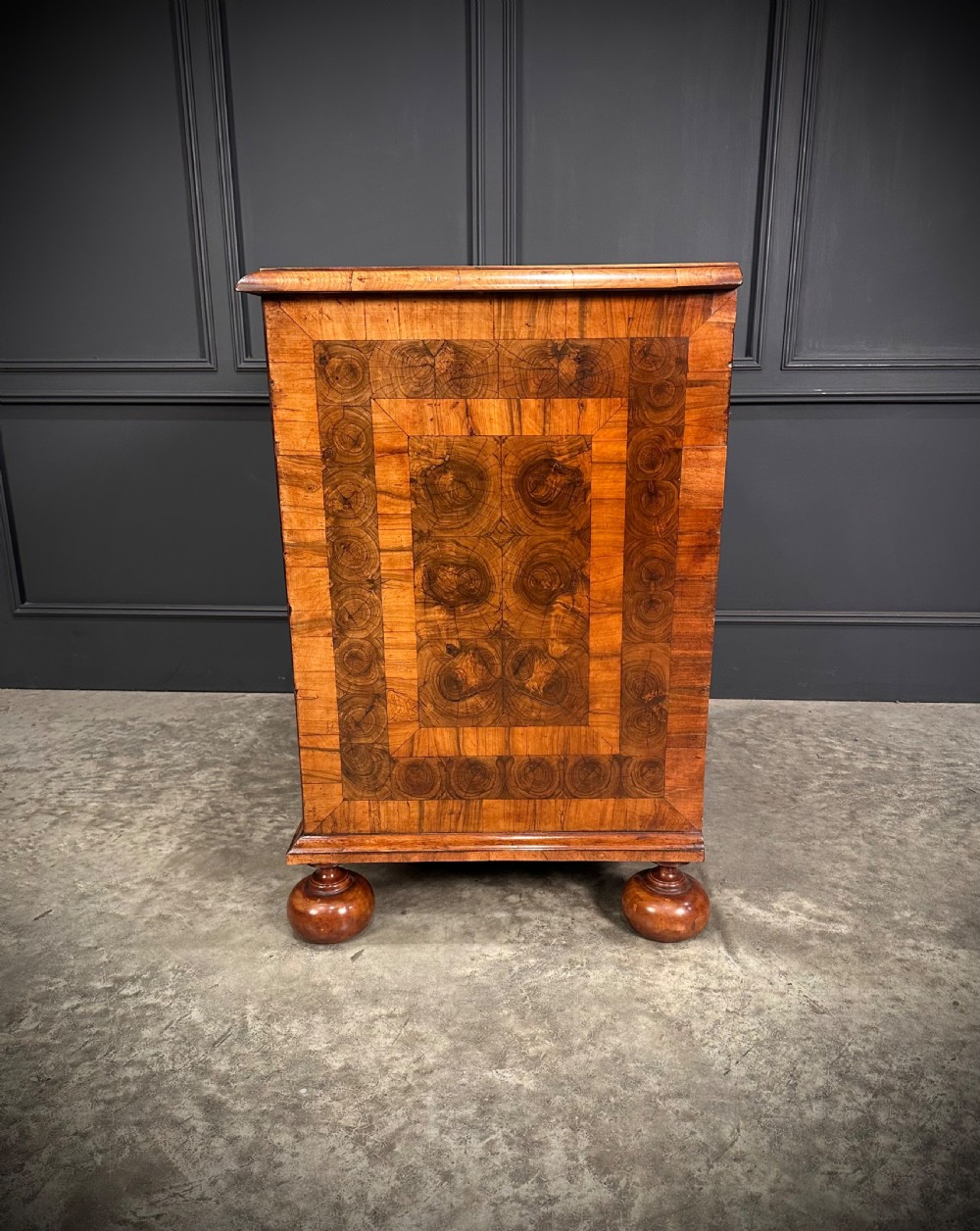 A William and Mary period walnut chest of drawers featuring geometric oyster veneering, brass teardrop handles, and turned bun feet. View XIII