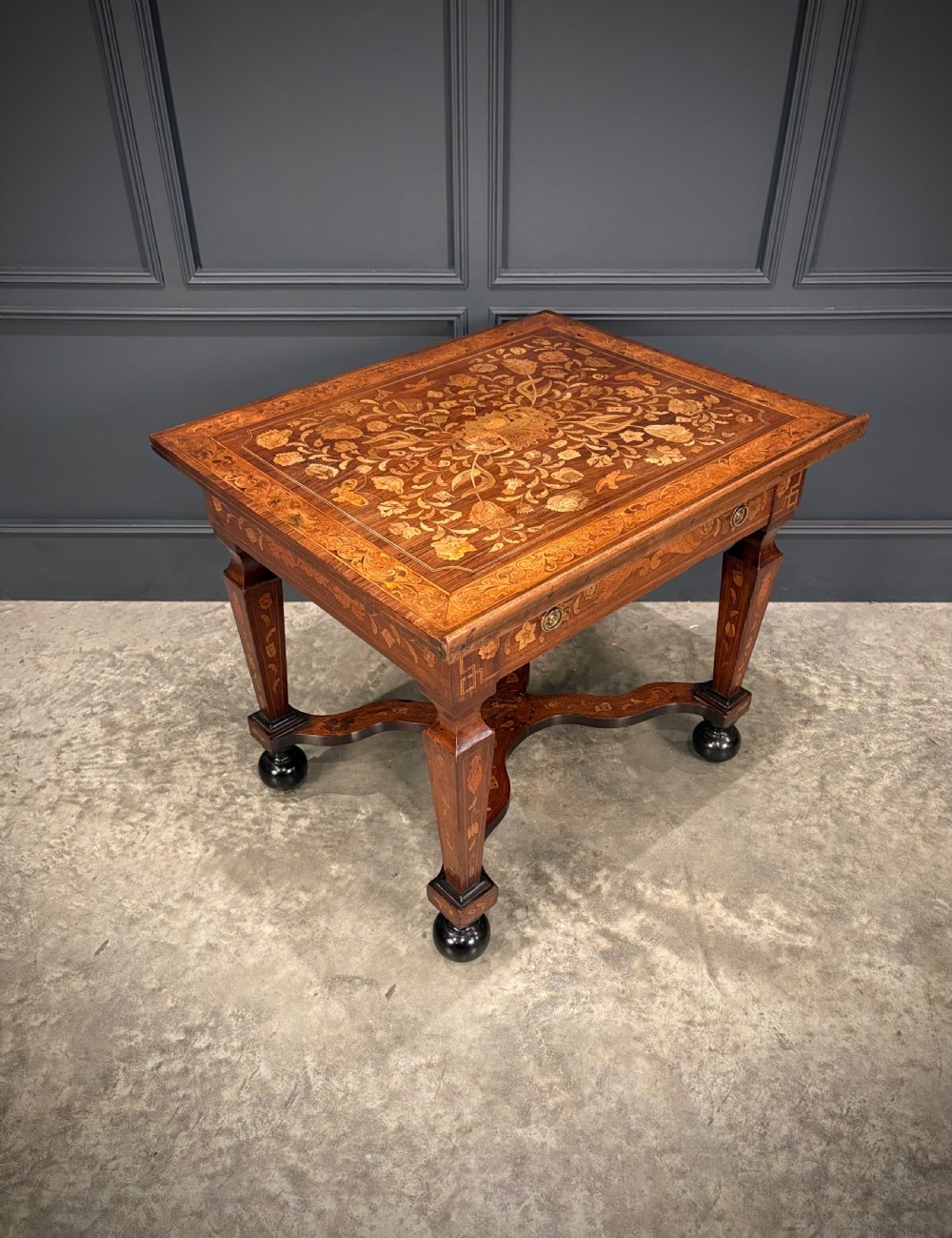 An eighteenth-century Dutch marquetry architects table featuring an adjustable tilted top decorated with floral wood inlays and resting on shaped legs with bun feet. View XV