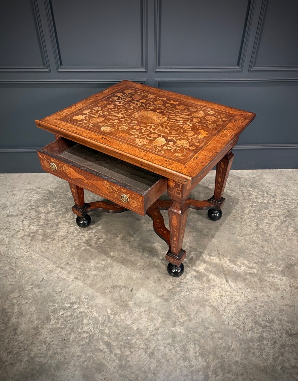 An eighteenth-century Dutch marquetry architects table featuring an adjustable tilted top decorated with floral wood inlays and resting on shaped legs with bun feet. View VII