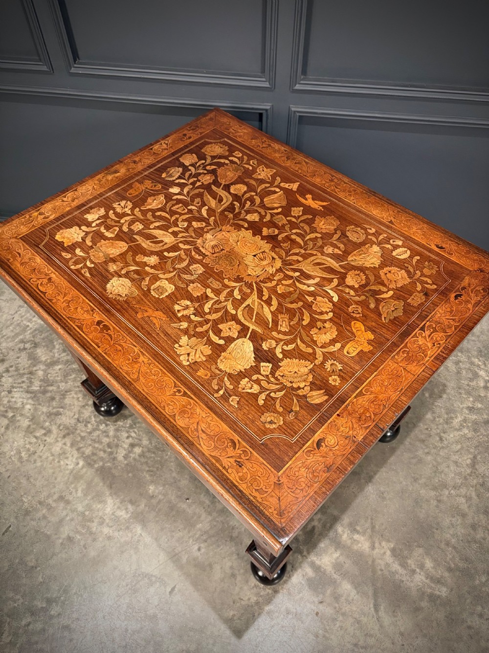 An eighteenth-century Dutch marquetry architects table featuring an adjustable tilted top decorated with floral wood inlays and resting on shaped legs with bun feet. View IX