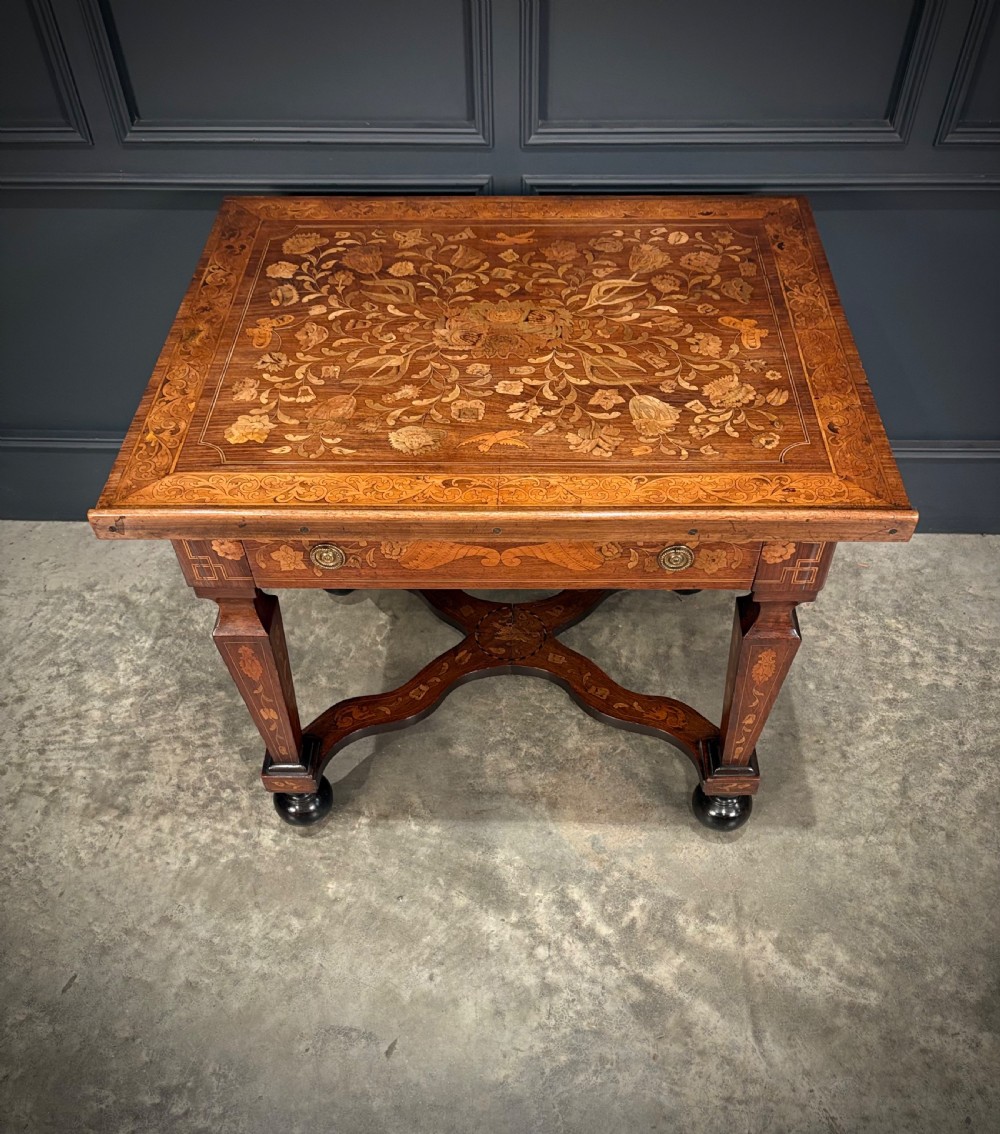 An eighteenth-century Dutch marquetry architects table featuring an adjustable tilted top decorated with floral wood inlays and resting on shaped legs with bun feet. View X