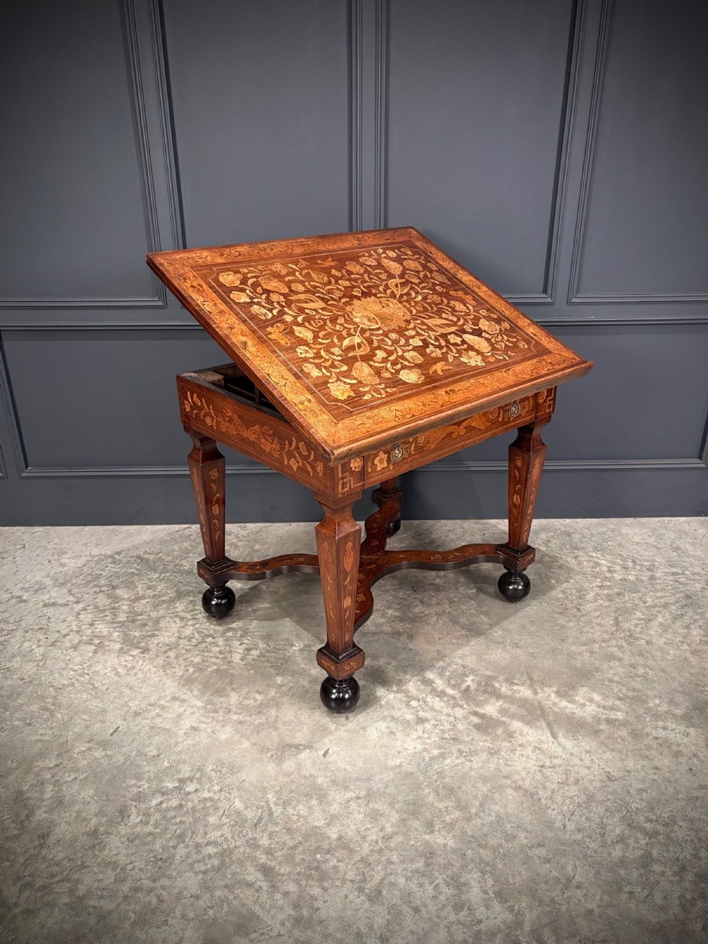 An eighteenth-century Dutch marquetry architects table featuring an adjustable tilted top decorated with floral wood inlays and resting on shaped legs with bun feet. View XI