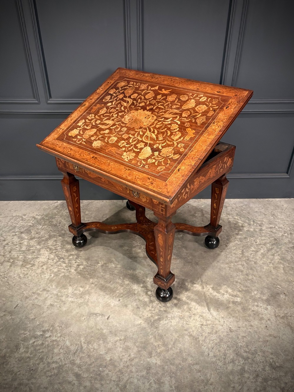 An eighteenth-century Dutch marquetry architects table featuring an adjustable tilted top decorated with floral wood inlays and resting on shaped legs with bun feet. View XIII