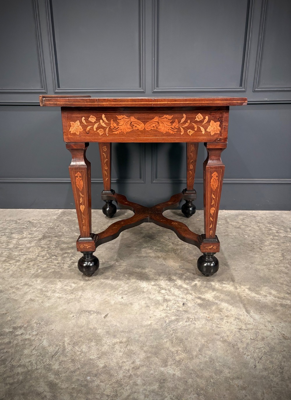 An eighteenth-century Dutch marquetry architects table featuring an adjustable tilted top decorated with floral wood inlays and resting on shaped legs with bun feet. View XVI