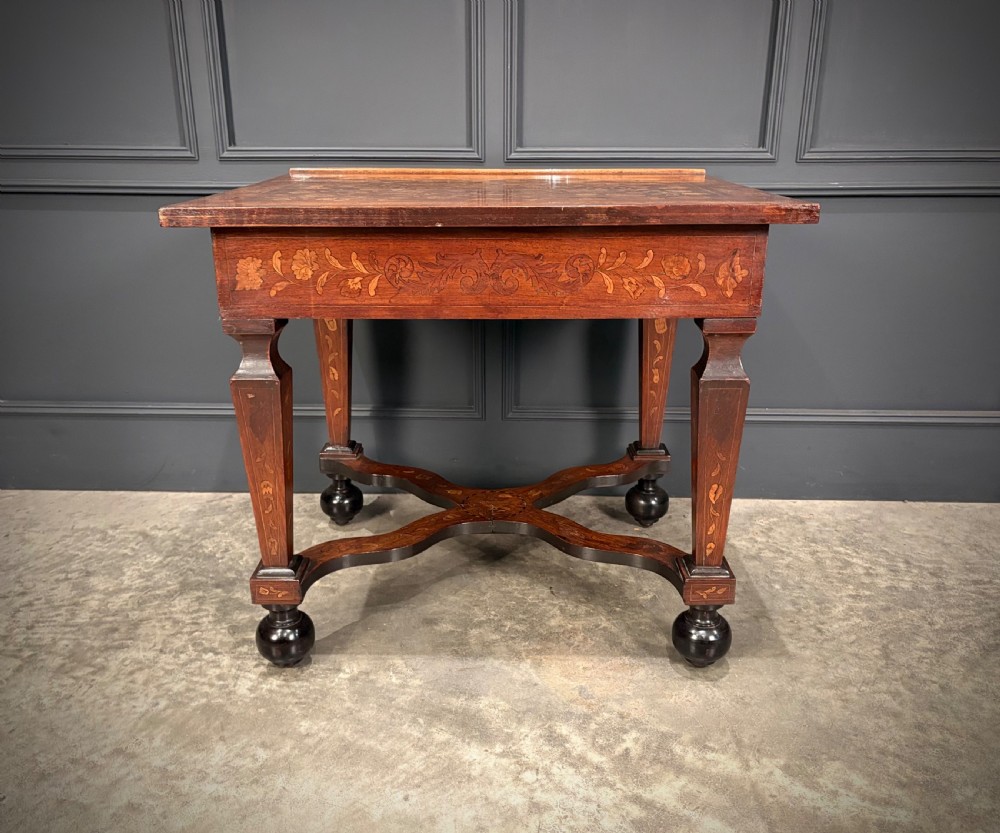 An eighteenth-century Dutch marquetry architects table featuring an adjustable tilted top decorated with floral wood inlays and resting on shaped legs with bun feet. View XVII