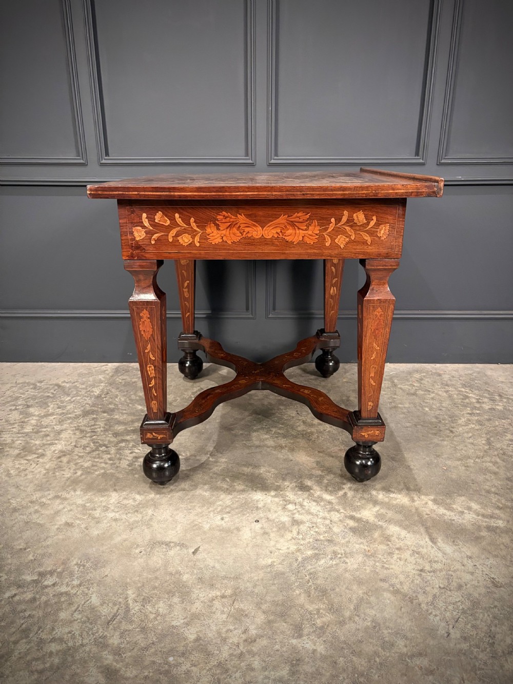 An eighteenth-century Dutch marquetry architects table featuring an adjustable tilted top decorated with floral wood inlays and resting on shaped legs with bun feet. View XVIII
