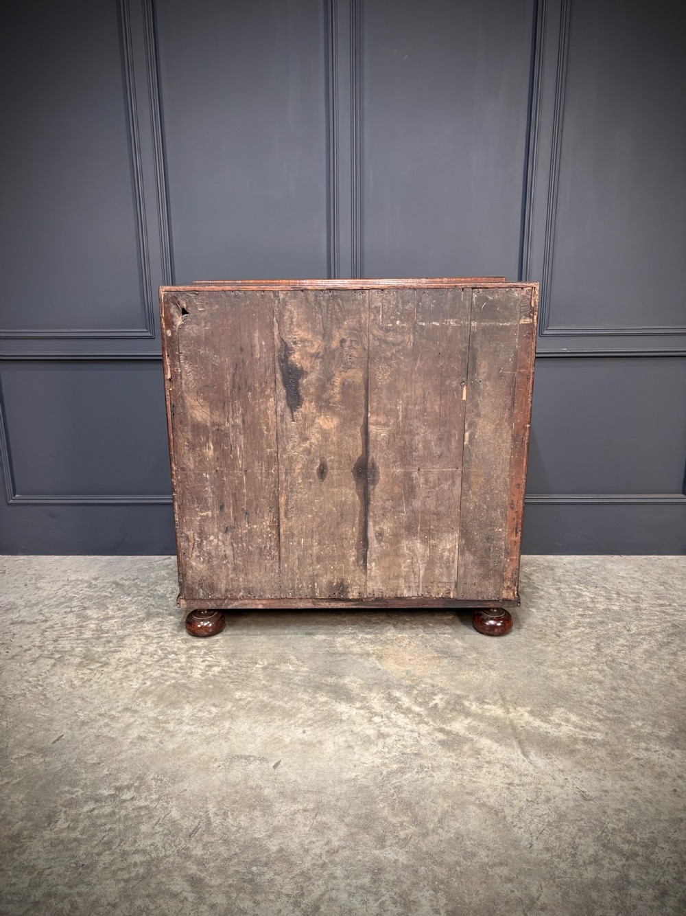 An antique Queen Anne walnut bureau featuring a sloping write-down front above drawers with brass handles, raised on compressed bun feet. View XI