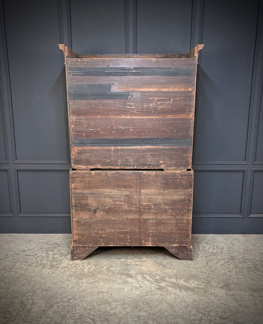 An 18th-century bleached oak chest on chest with stacked upper and lower drawer sections, brass drop handles, and bracket feet. View VII
