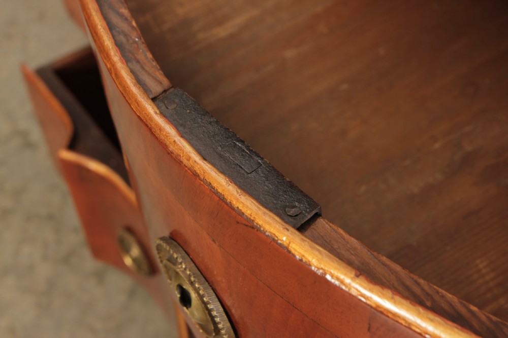 An antique walnut serpentine-front chest featuring four drawers with brass ring pull handles resting on carved cabriole feet. View VIII