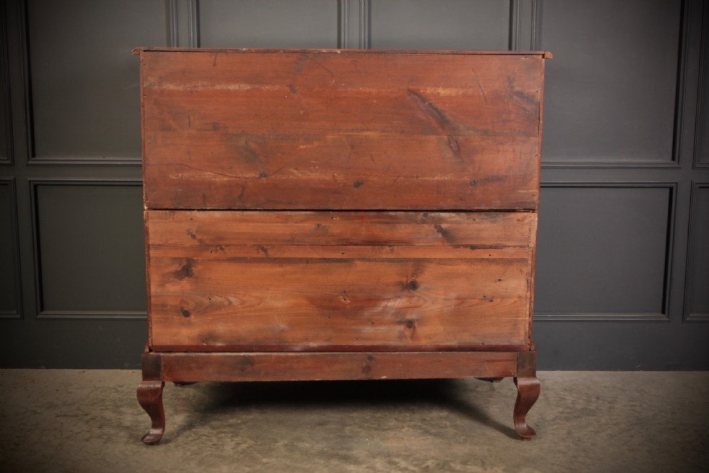 An antique walnut serpentine-front chest featuring four drawers with brass ring pull handles resting on carved cabriole feet. View X