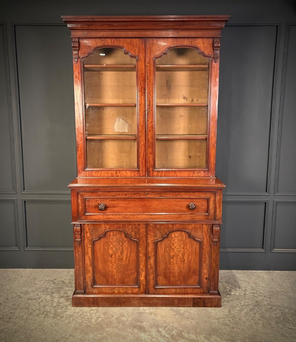 A tall Victorian mahogany secretaire bookcase featuring an upper two-door glazed cabinet over a writing drawer and lower cupboard base. View XVI