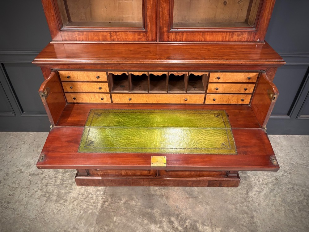 A tall Victorian mahogany secretaire bookcase featuring an upper two-door glazed cabinet over a writing drawer and lower cupboard base. View II