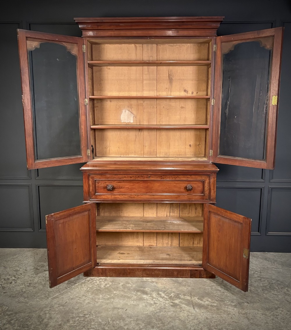 A tall Victorian mahogany secretaire bookcase featuring an upper two-door glazed cabinet over a writing drawer and lower cupboard base. View IV